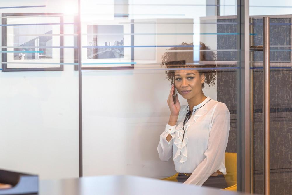 You Dont Need Office Space - Woman on Phone in Booth Bright